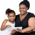 African mother with little daughter holding tablet. Royalty Free Stock Photo