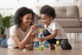 African mother with little kid son play with wooden blocks Royalty Free Stock Photo