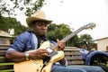 African Musician Kunle Ayo, Nigeria playing guitar on a farm