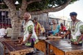 African musicians in traditional shirts make music at the Waterfront in Cape Town, South Africa. Royalty Free Stock Photo