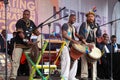 African musicians in traditional garb at the outdoor cultural event