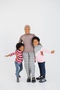 African muslim woman in hijab embracing her daughters in studio Royalty Free Stock Photo