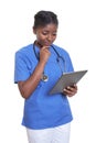 African nurse looking at tablet computer Royalty Free Stock Photo