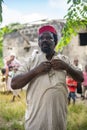 An African Older Man, The Mayor of His Village in Red Muslim Taqiyyah Hat and White Dress. Small Remote Village in Royalty Free Stock Photo