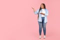 African Oversized Woman Pointing Aside Showing Copy Space, Pink Background