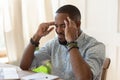 African overworked man suffers from migraine severe headache Royalty Free Stock Photo