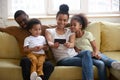 African parents and kids having fun making selfie using smartphone