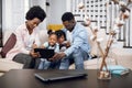 African parents with kids using tablet while resting on couch Royalty Free Stock Photo