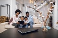 African parents with kids using tablet while resting on couch Royalty Free Stock Photo