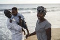 African parents and little son having fun on the beach at sunset - Main focus on mother face