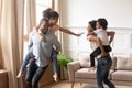 African parents playing with kids carrying them on back Royalty Free Stock Photo