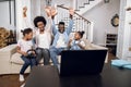 African parents playing video games on laptop with kids Royalty Free Stock Photo