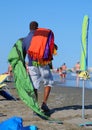 African peddler of fabrics and towels on the beach in summer