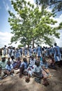 African people shading under a tree in the heat of the sun