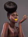 African, person and studio face with makeup, beauty and creative yellow lipstick. Bold, woman and skin with confidence