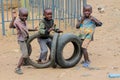 African poor boys play with wheels
