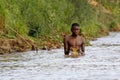 African poor man taking a bath in river