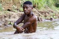 African poor man taking a bath in river