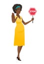 African pregnant woman holding stop road sign.