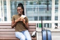 African pretty businesswoman with air ticket at airport waiting for flight Royalty Free Stock Photo