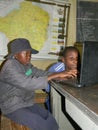 African primary schoolkids using laptop at school.