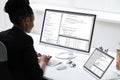 African Programmer Or Coder Using Multiple Monitors Royalty Free Stock Photo