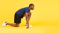 African Runner Guy Standing In Crouch Start Position, Yellow Background Royalty Free Stock Photo