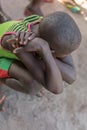 African rural boy, crouched.