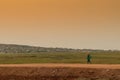 African rural people returning from work, with sunset. Sumbe. An