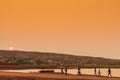 African rural people returning from work, with sunset. Sumbe. An