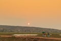 African rural people returning from work, with sunset. Sumbe. An