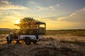 African safari vehicle in the Hobatere game reserve with dramatic sunset