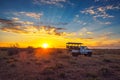 African safari vehicle stops in the Kalahari desert for dramatic sunset Royalty Free Stock Photo