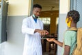 School teacher dispensing hand sanitizer for a school child Royalty Free Stock Photo