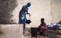 African Schoolgirls Collecting Water from Malian Well Royalty Free Stock Photo