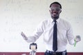 African scientist teacher is  holding  test tube with chemical liquid.Black man is teaching science classes with using microscope Royalty Free Stock Photo