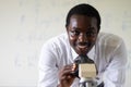 African scientist teacher looking microscopes in the laboratory