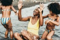 African sisters twins playing on the beach with smiling mother - Black family people having fun on summer time - Main focus on mum Royalty Free Stock Photo