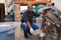 Confectionary factory worker pouring melted chocolate into a bowl Royalty Free Stock Photo