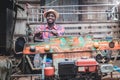 African smiling man farmer driving old vintage tractor with trailer on farm.Concept of agriculture and cultivation Royalty Free Stock Photo