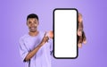 African smiling man finger point at phone with large mockup display