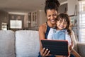 African smiling mother and happy daughter using digital tablet Royalty Free Stock Photo