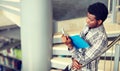 African student boy or man reading book at library Royalty Free Stock Photo