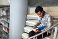 African student boy or man reading book at library Royalty Free Stock Photo