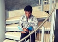 African student boy or man reading book on stairs Royalty Free Stock Photo