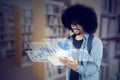 African student with futuristic screen in the library Royalty Free Stock Photo