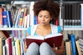 African student girl reading book at library Royalty Free Stock Photo