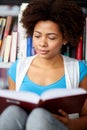 African student girl reading book at library Royalty Free Stock Photo