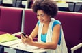 African student girl with smartphone on lecture Royalty Free Stock Photo