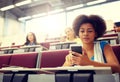 African student girl with smartphone at lecture Royalty Free Stock Photo